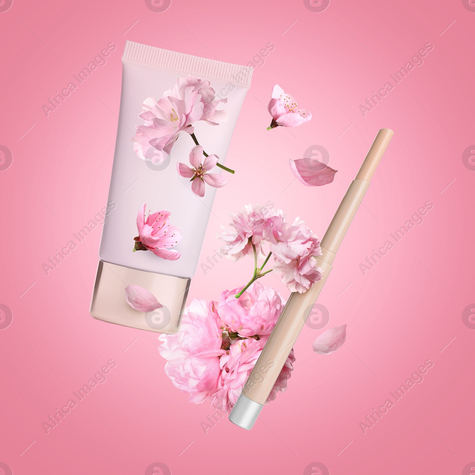 Image of Spring flowers and makeup products in air on pink background