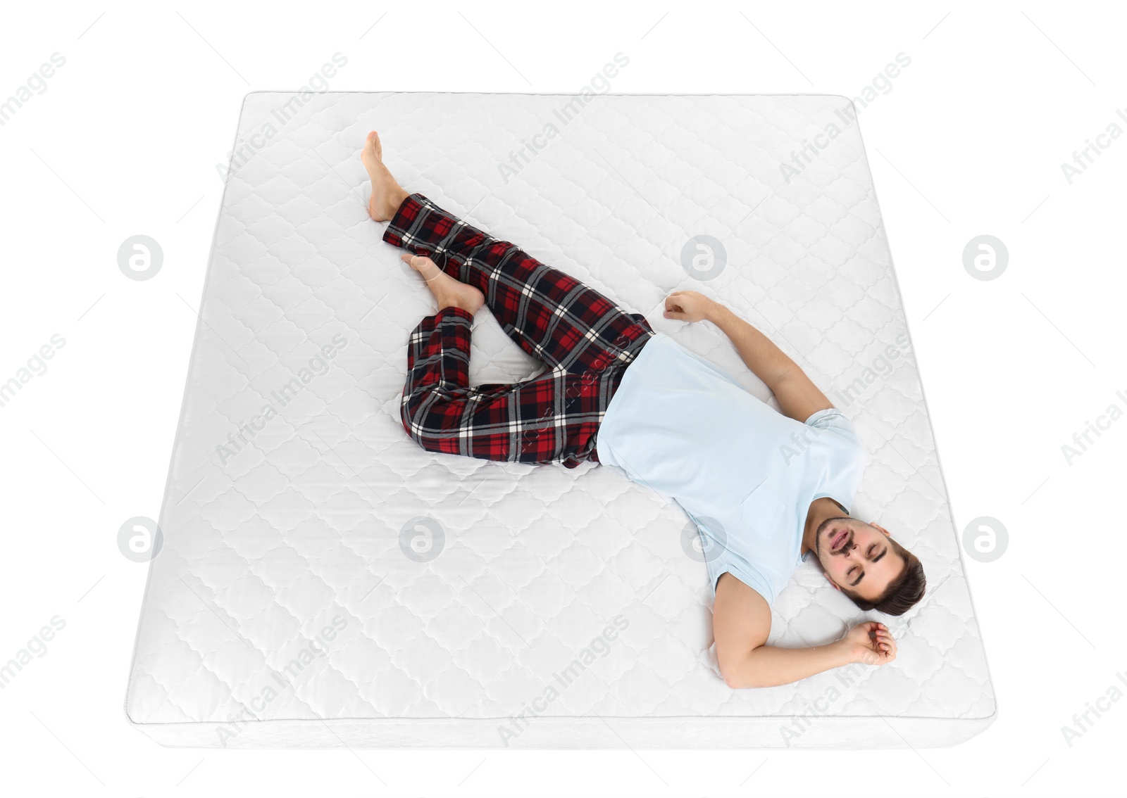 Photo of Young man sleeping on mattress against white background, above view