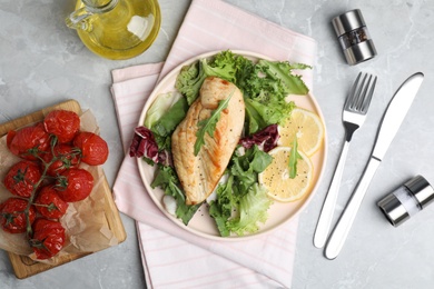 Photo of Delicious cooked chicken and fresh salad served on grey marble table, flat lay. Healthy meals from air fryer