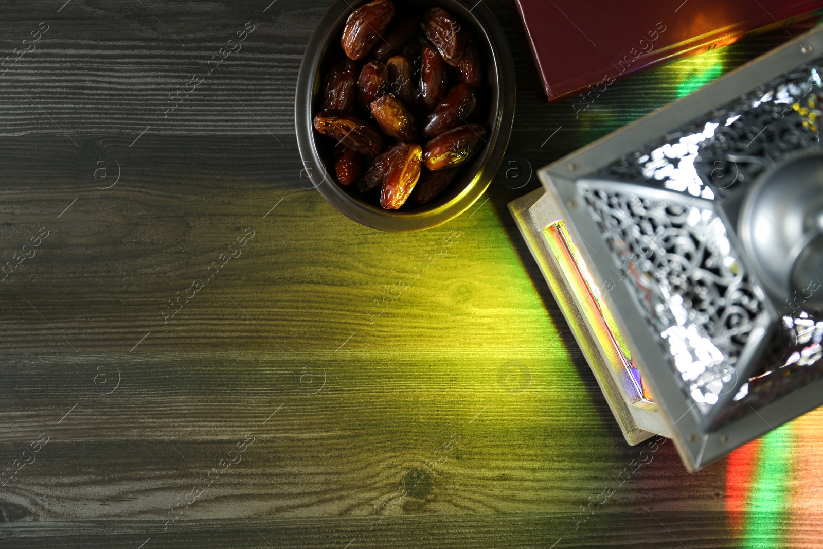 Photo of Decorative Arabic lantern and dates on wooden table, flat lay. Space for text