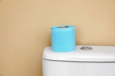 Photo of Paper roll on toilet tank in bathroom