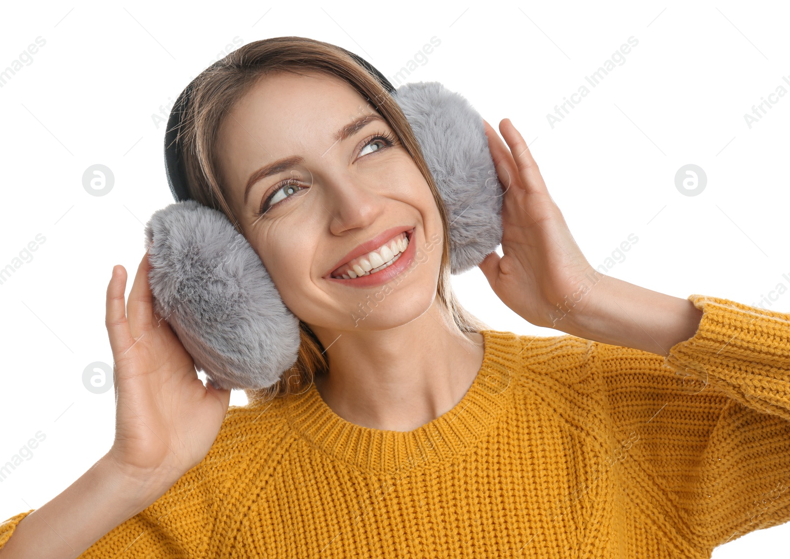 Photo of Happy woman wearing warm earmuffs on white background