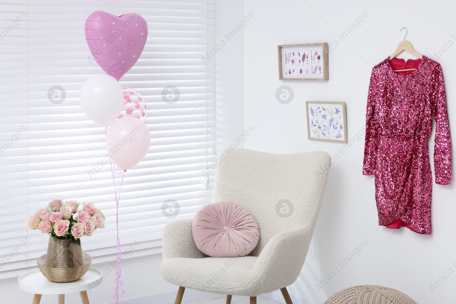 Photo of Shiny glitter dress, beautiful roses on coffee table and air balloons in cozy room. Preparing for birthday party