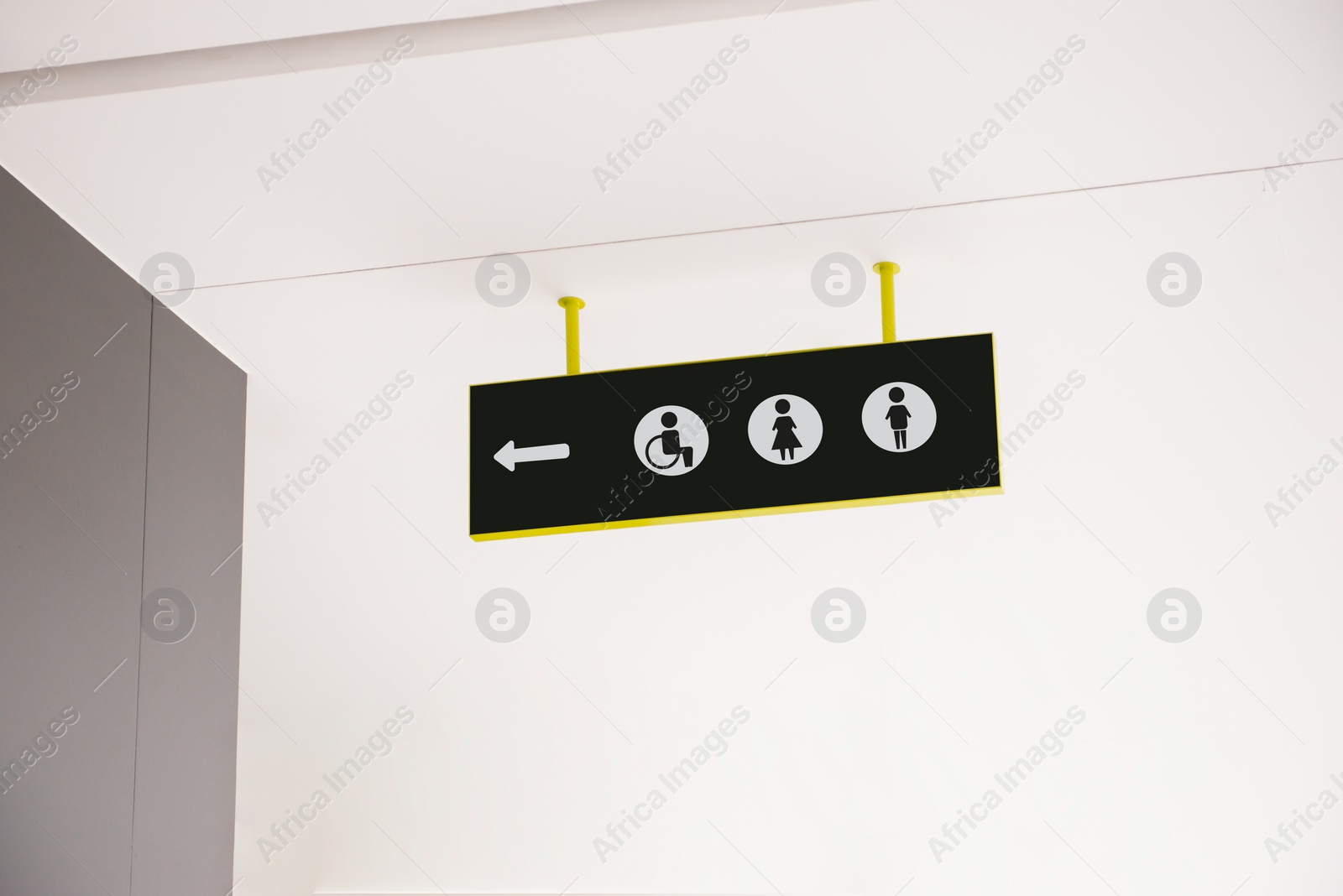 Image of Public toilet sign with symbols and arrow showing direction