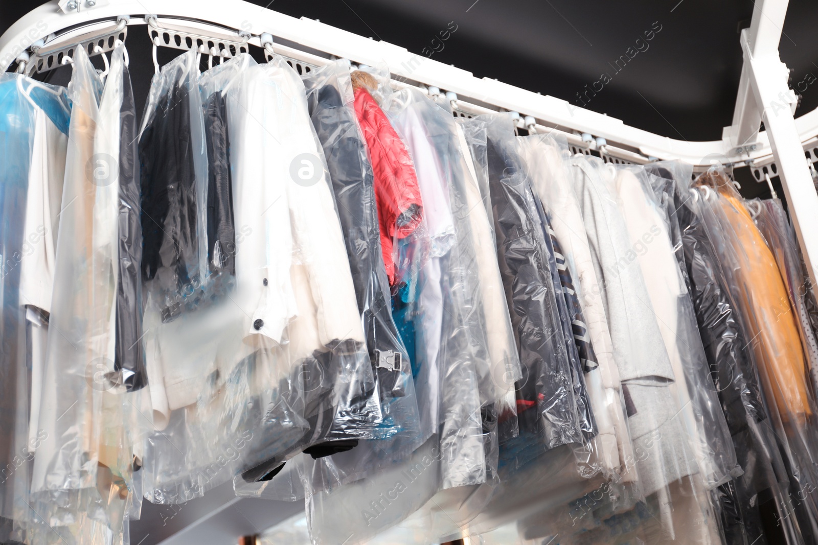Photo of Hangers with clothes on garment conveyor at dry-cleaner's