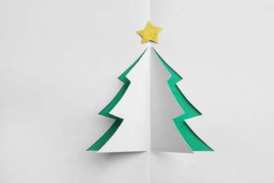 Photo of Christmas tree cut out of white paper, top view