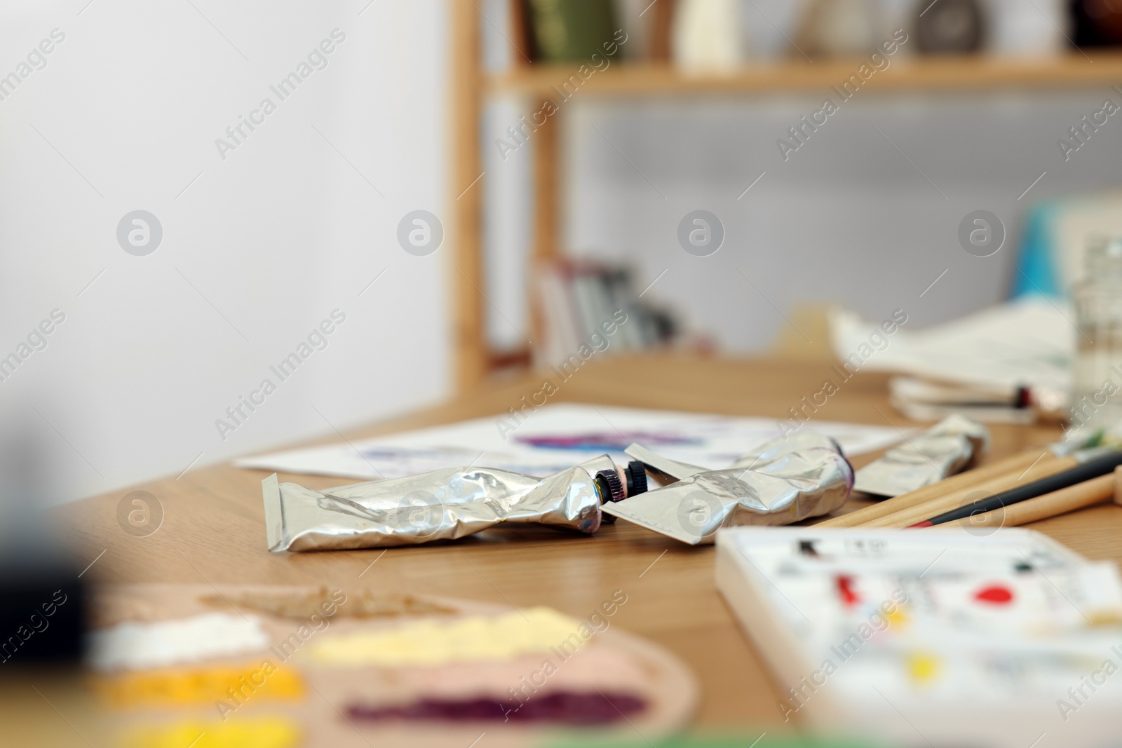 Photo of Many painting tools on wooden table indoors, closeup. Creative hobby