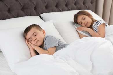 Cute little children sleeping in comfort bed