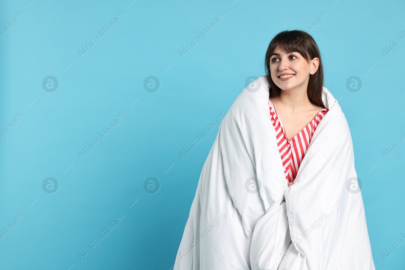 Photo of Happy woman with pyjama wrapped in blanket, space for text