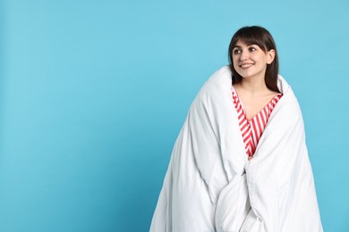 Photo of Happy woman with pyjama wrapped in blanket, space for text