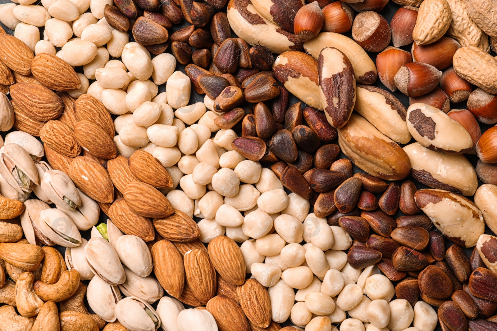 Photo of Organic mixed nuts as background, top view