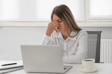 Photo of Sleepy young woman at workplace in office