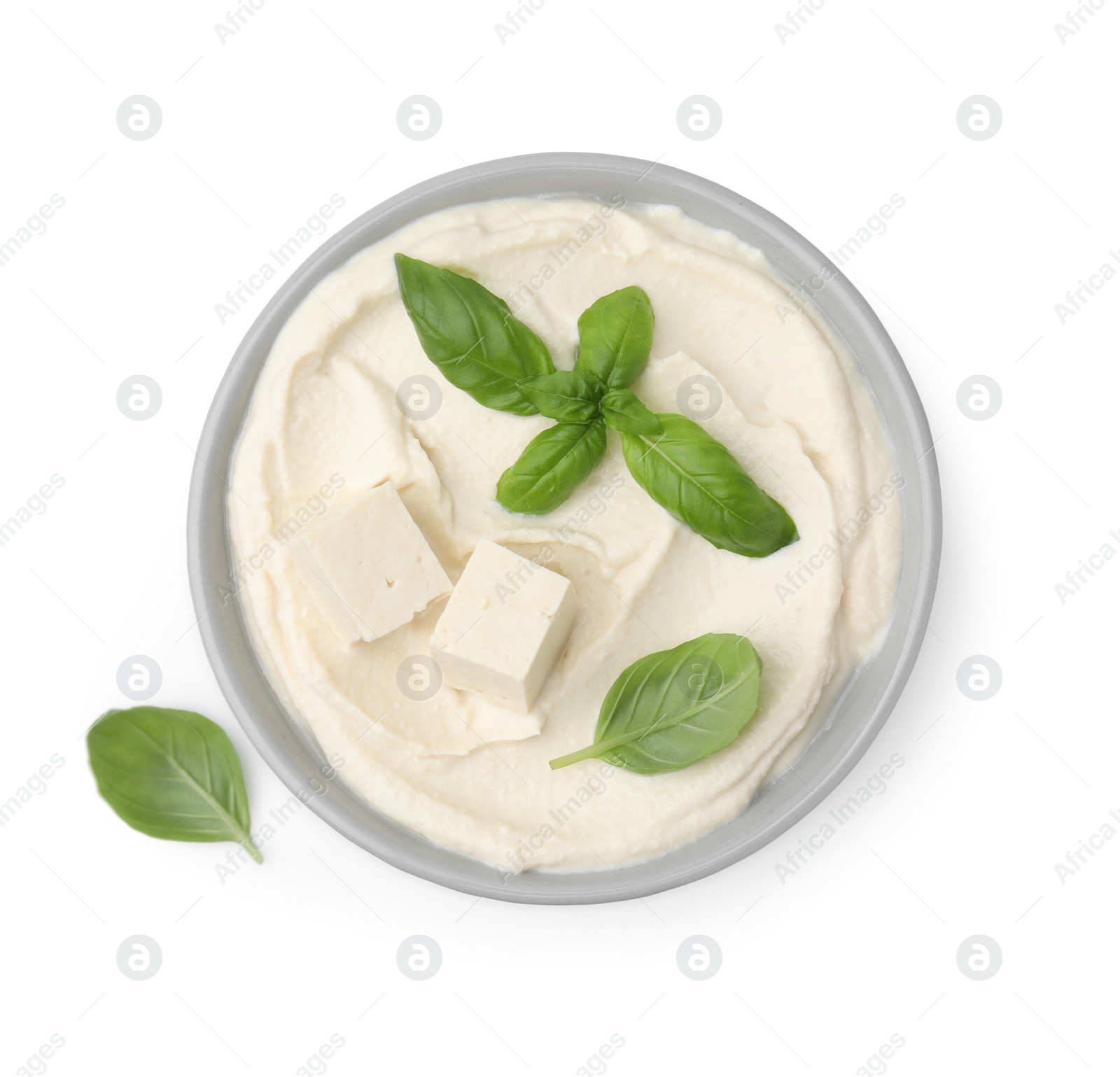 Photo of Delicious tofu sauce and basil leaves isolated on white, top view