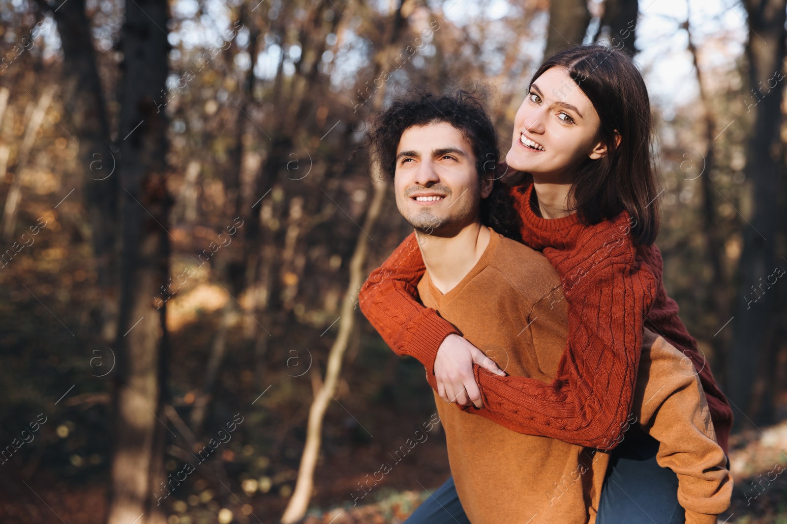 Photo of Happy young couple spending time together in autumn park, space for text. Dating agency