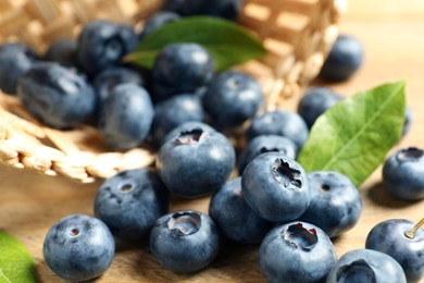 Photo of Fresh tasty blueberries on wooden table, closeup