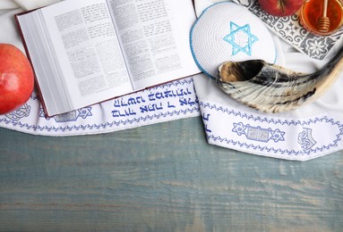 Photo of Flat lay composition with Rosh Hashanah holiday symbols on wooden table. Space for text
