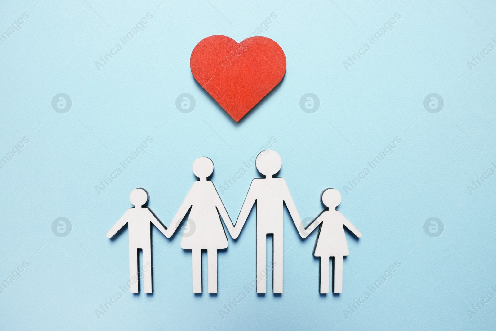 Photo of Figures of family and heart on light blue background, top view. Insurance concept