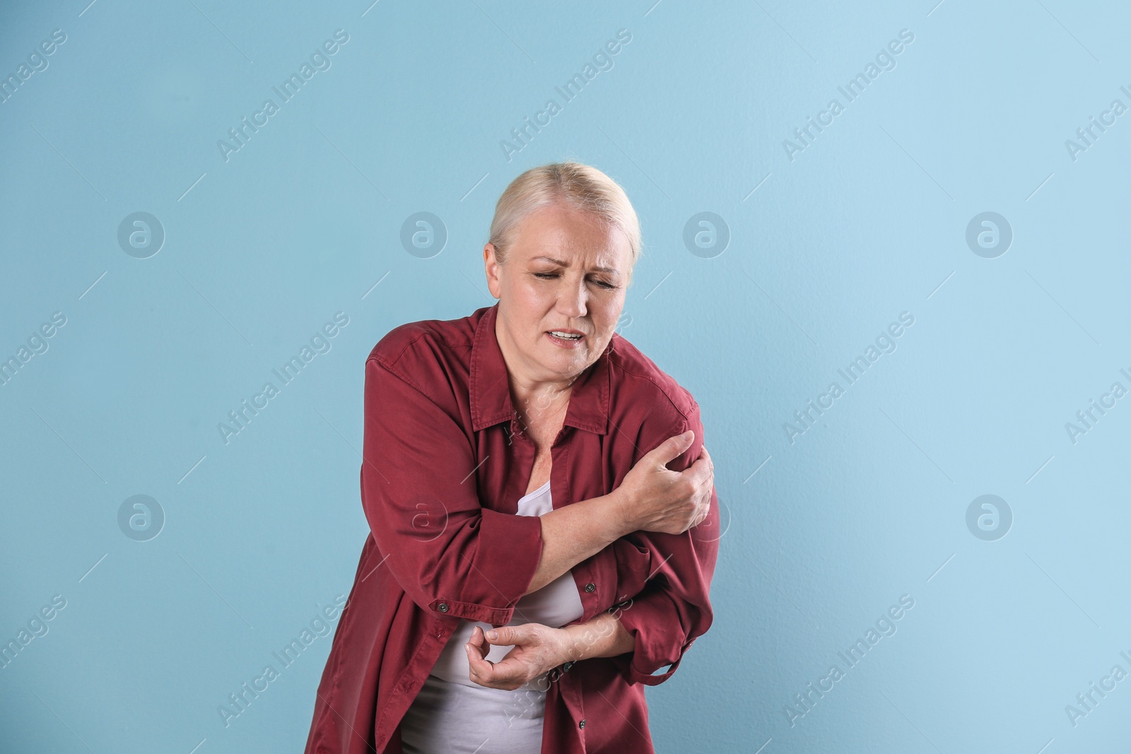 Photo of Mature woman having heart attack on color background