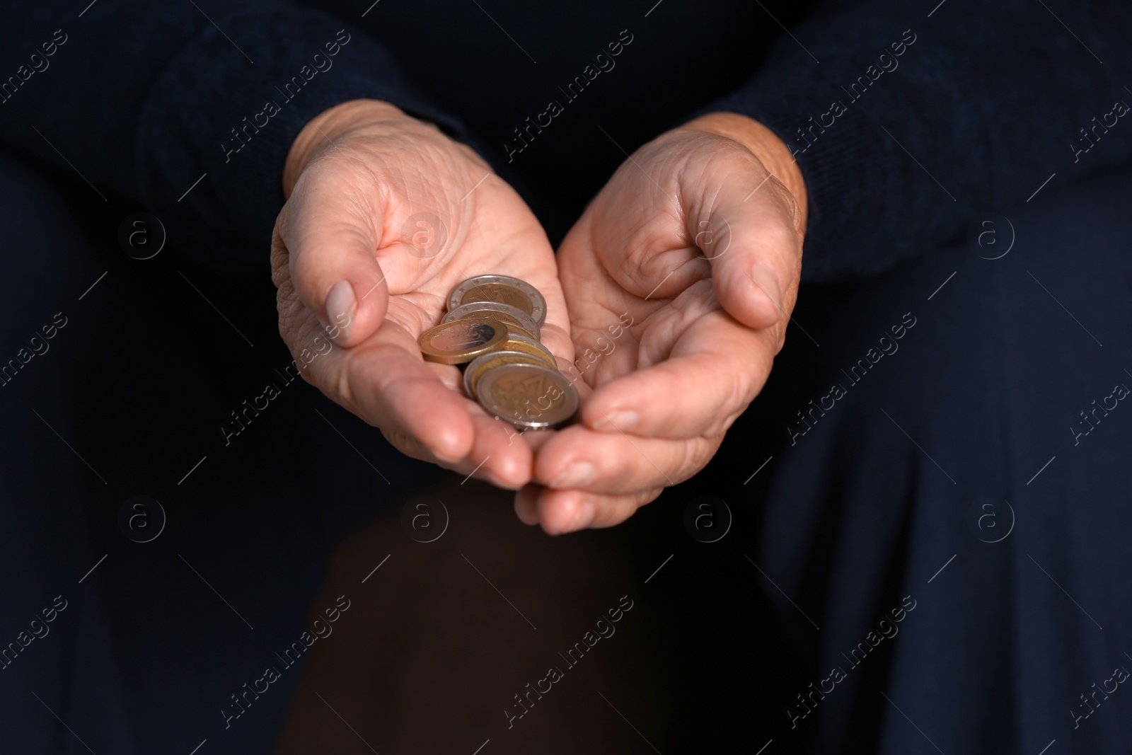 Photo of Poor elderly woman holding coins, focus on hands