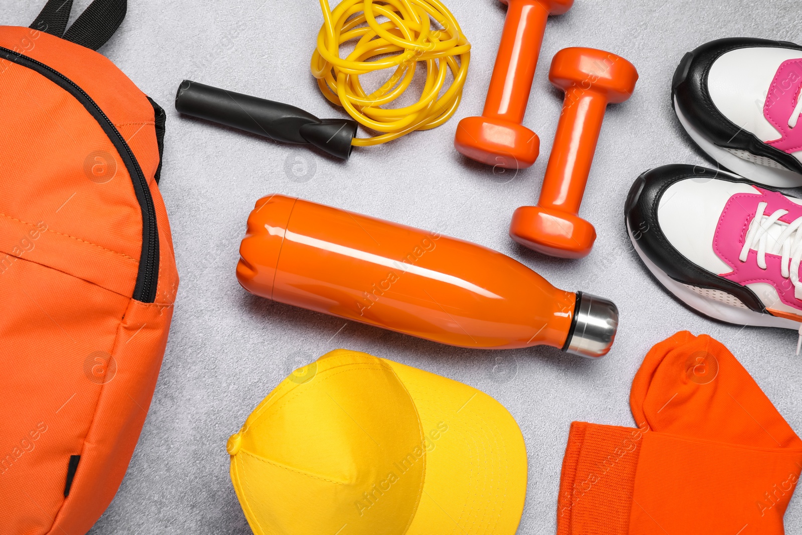 Photo of Different sports equipment on light grey table, flat lay