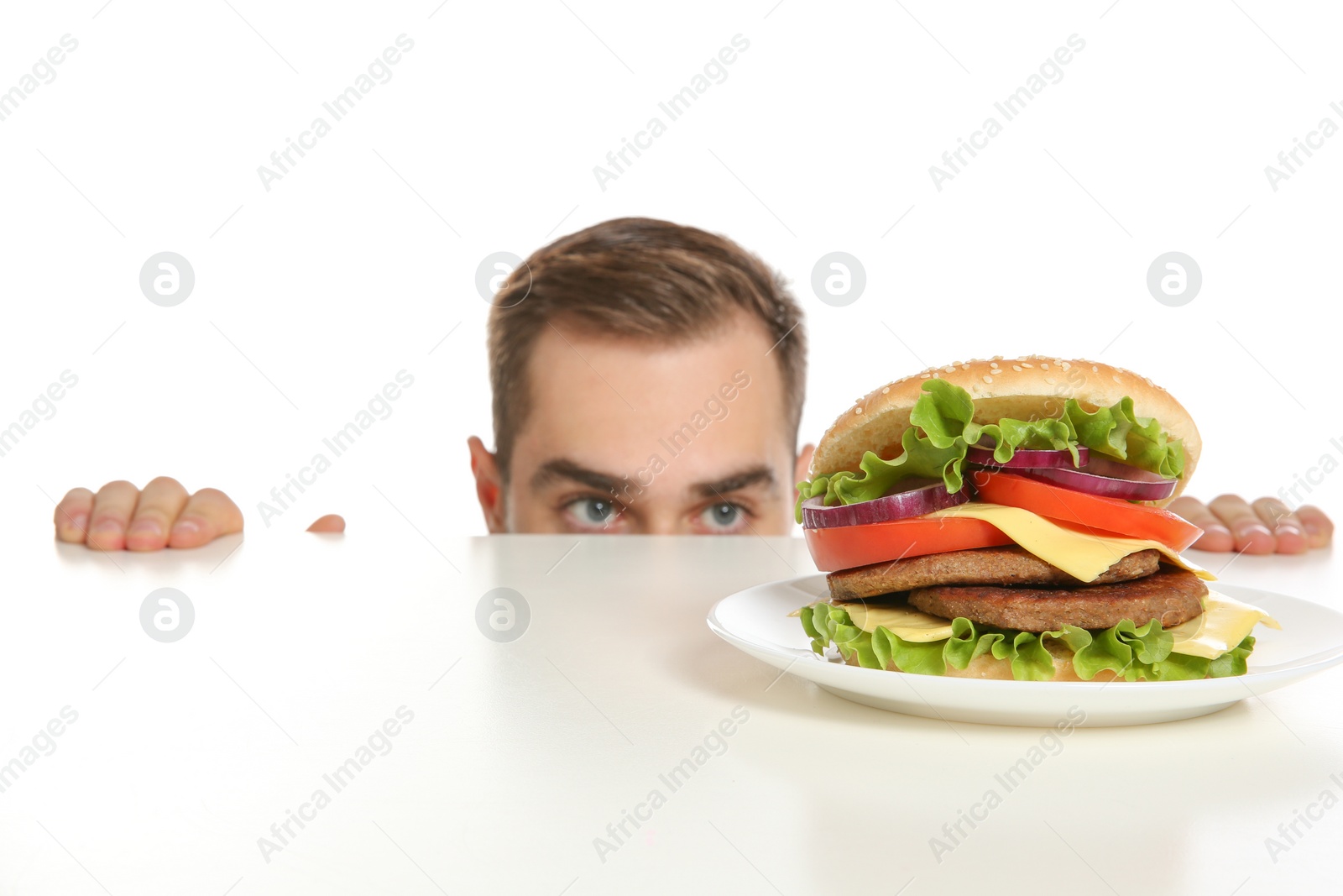 Photo of Young man with tasty burger on white background