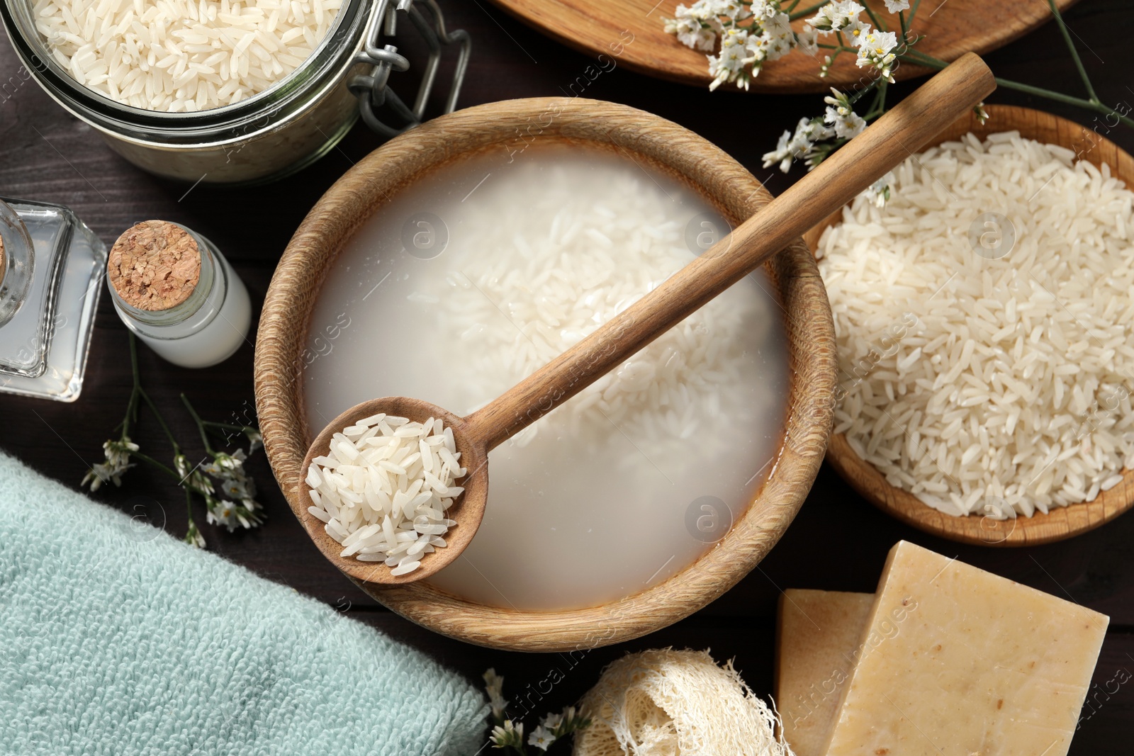 Photo of Flat lay composition with soaked rice on wooden table