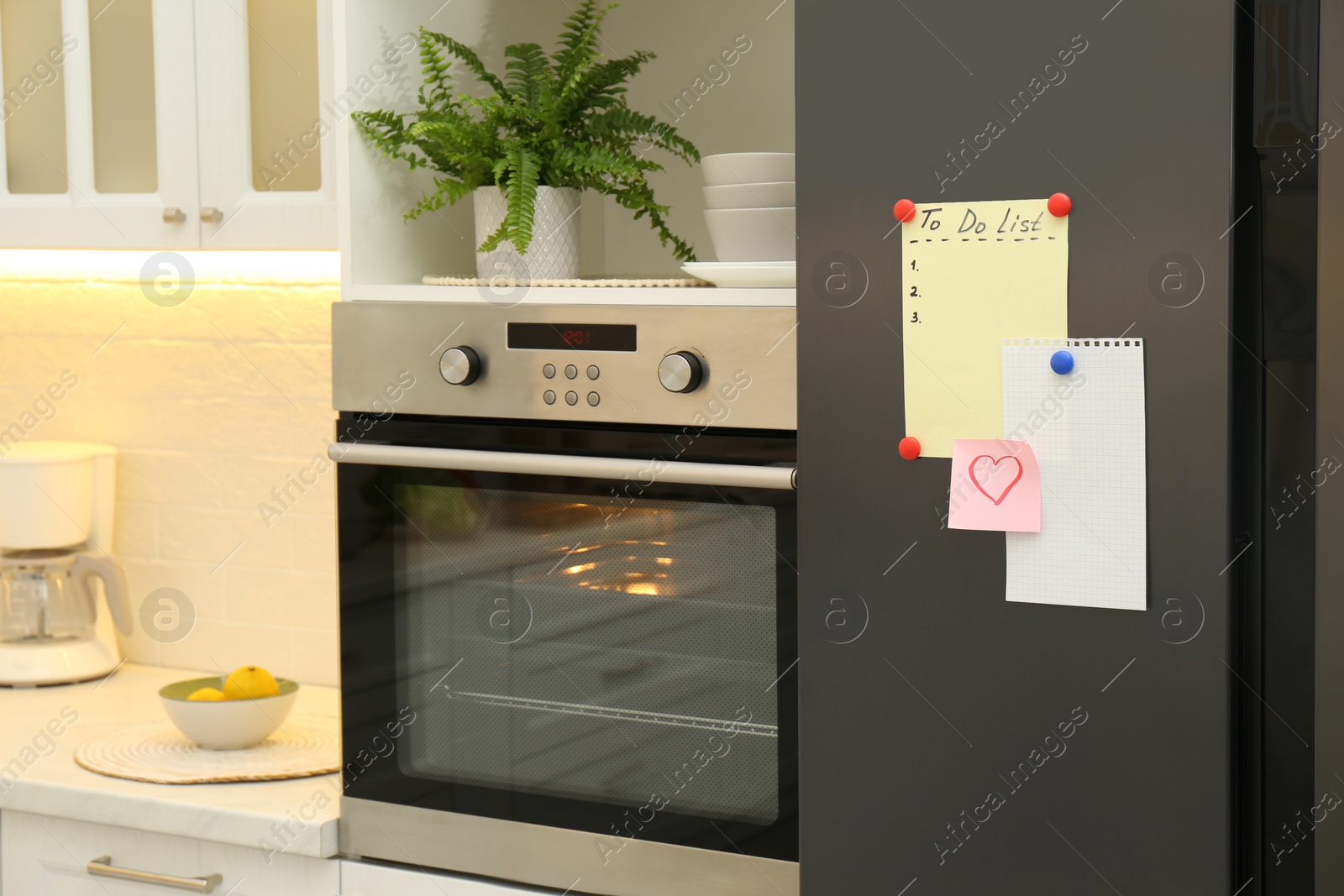 Photo of Blank To do list, sticky note and paper on fridge in kitchen. Space for text