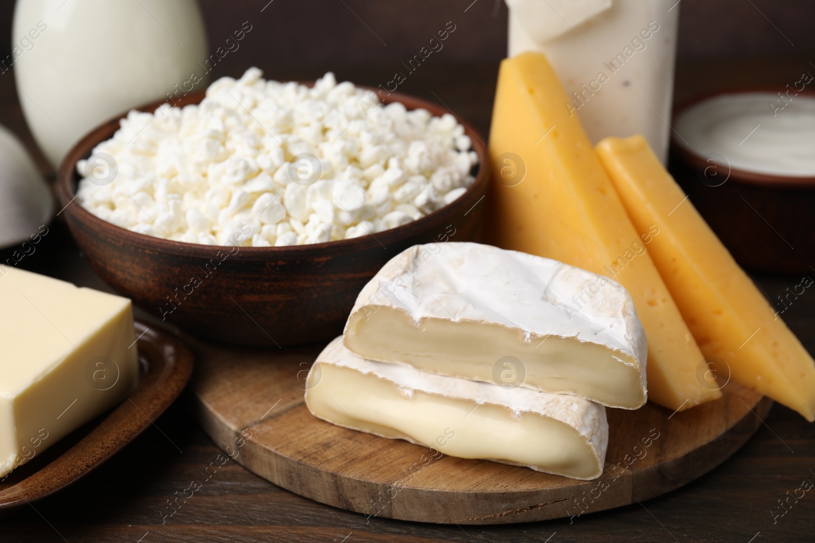 Photo of Different fresh dairy products on wooden table, closeup