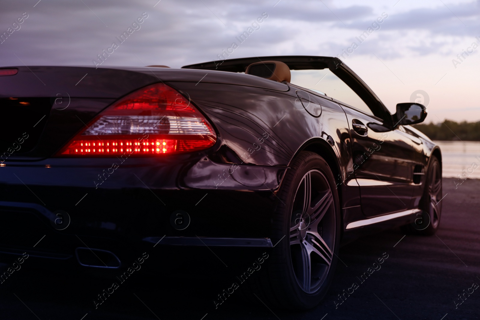 Photo of Luxury black convertible car outdoors in evening