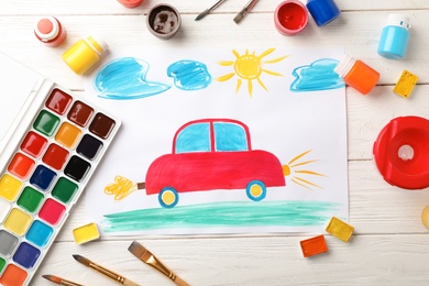 Photo of Flat lay composition with child's painting of car on table