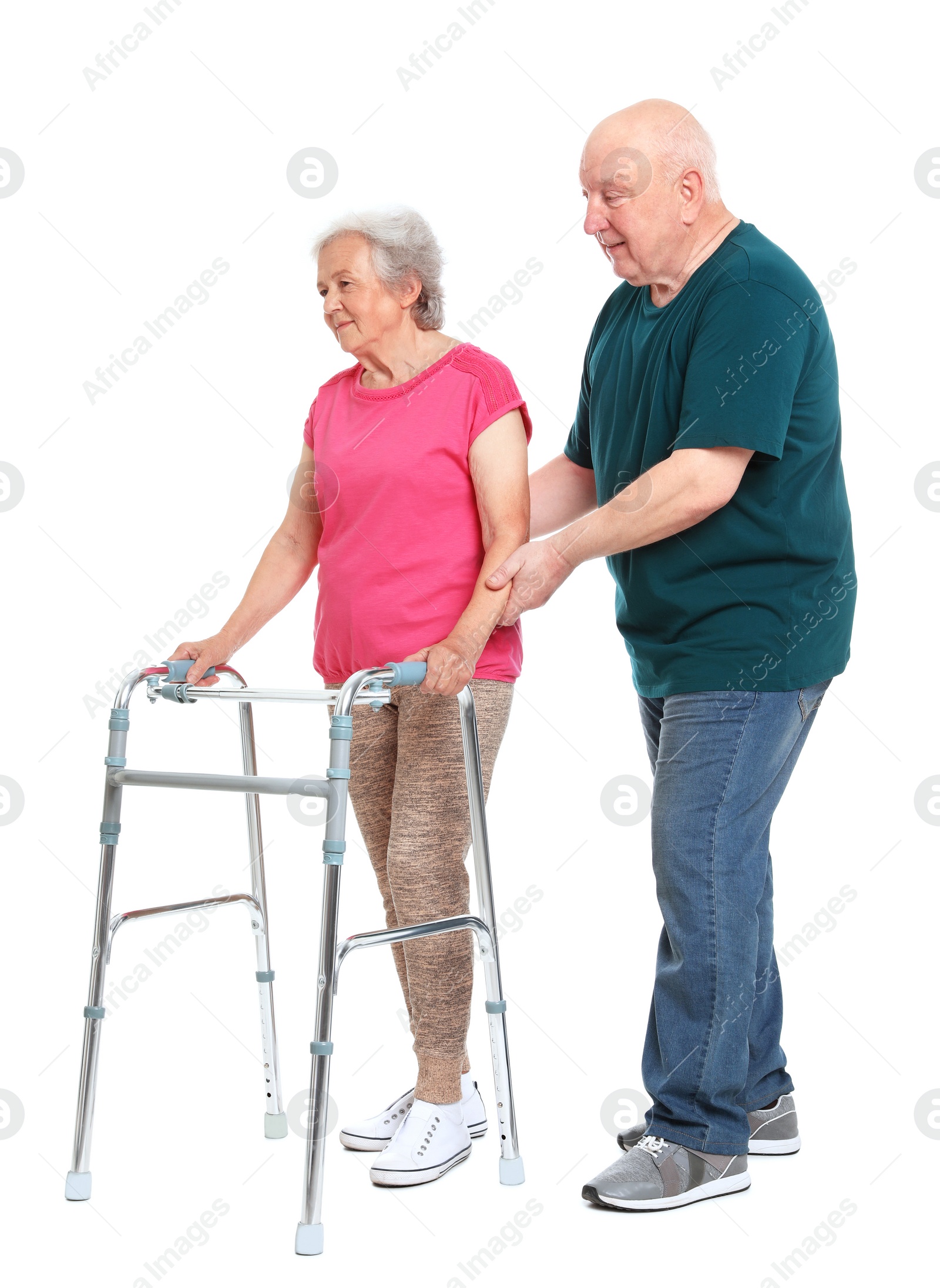 Photo of Elderly man helping his wife with walking frame on white background