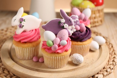 Photo of Tasty cupcakes with Easter decor on table