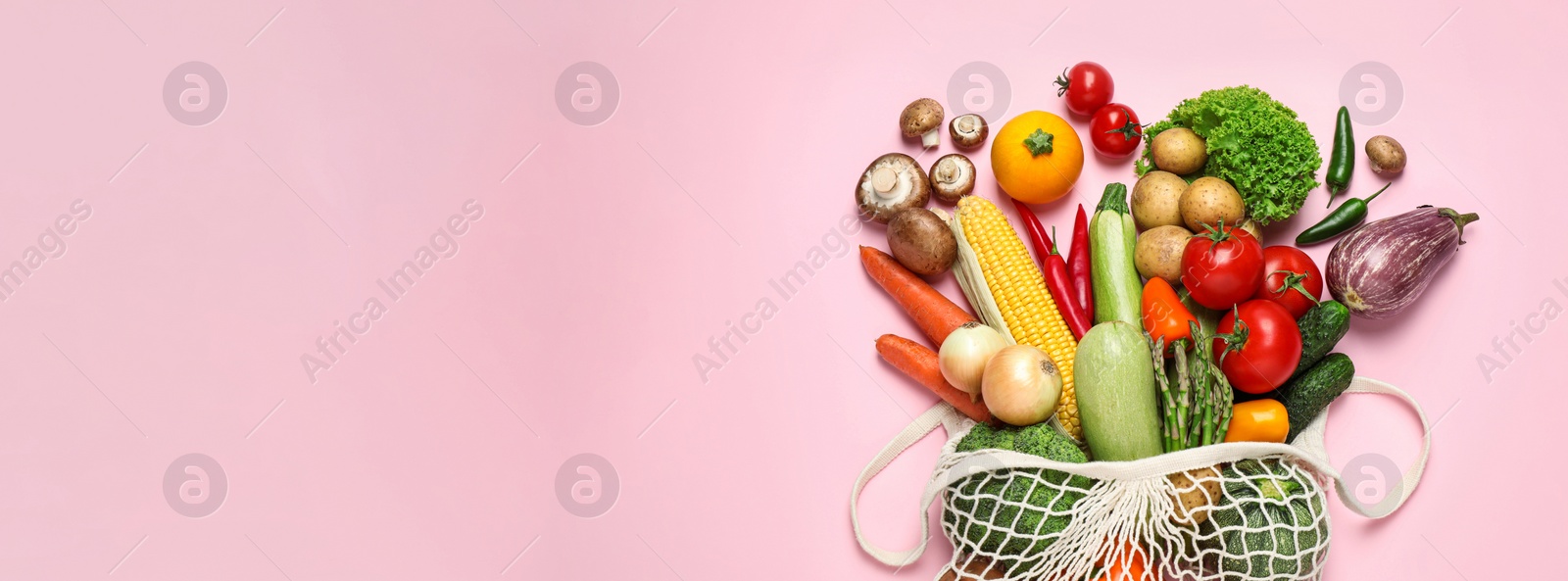Image of Many fresh different vegetables on pale pink background, top view with space for text. Banner design 