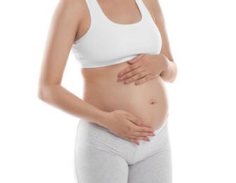 Beautiful pregnant woman holding belly on white background, closeup