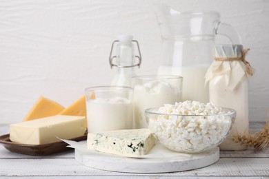 Different fresh dairy products on white wooden table