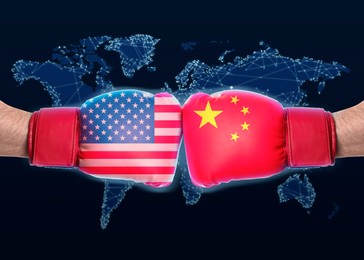 Men in boxing gloves with American and Chinese flags fighting, closeup.Trade war