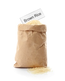 Photo of Paper bag with uncooked brown rice and card on white background