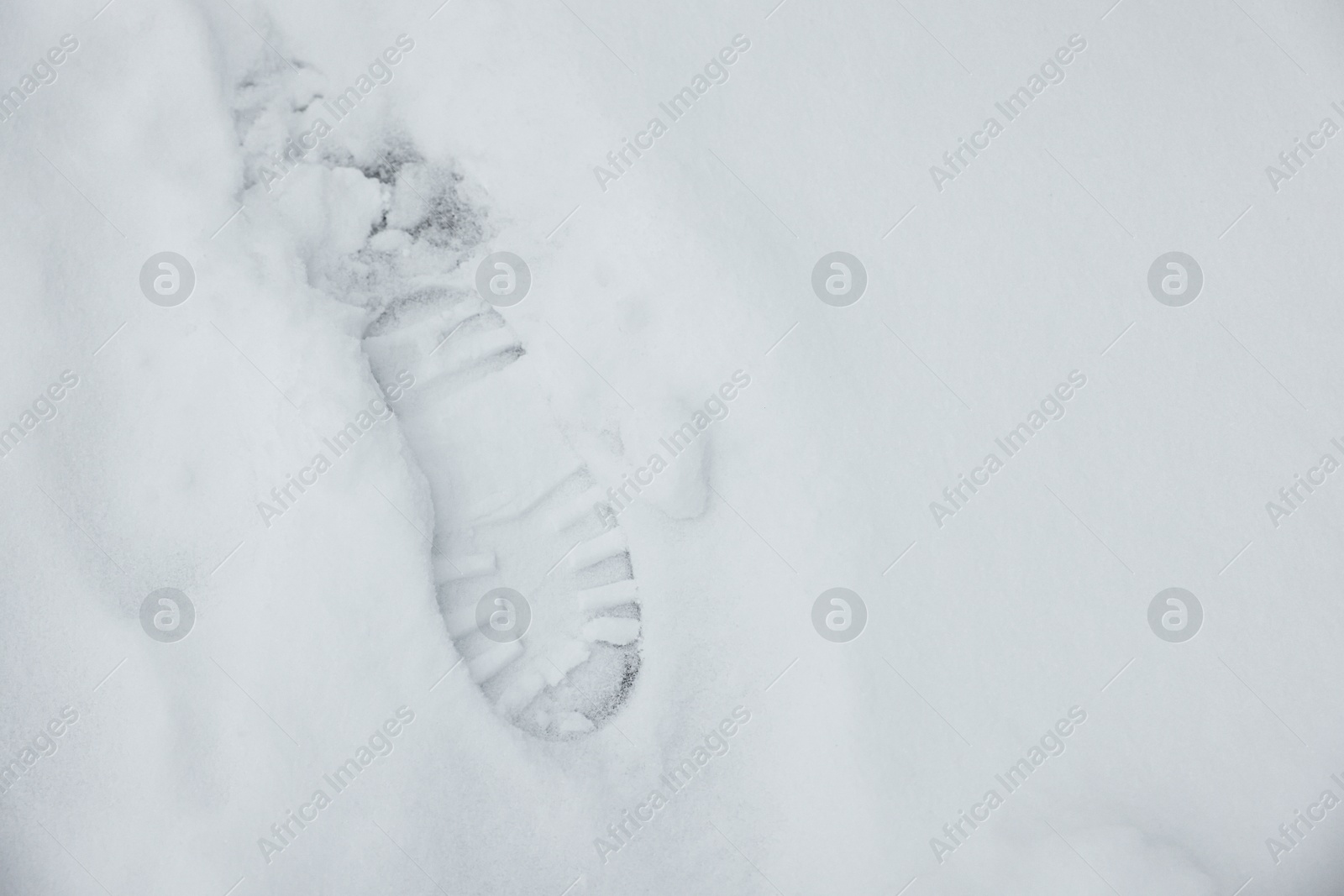 Photo of Top view of footprint on white snow outdoors, space for text. Winter weather