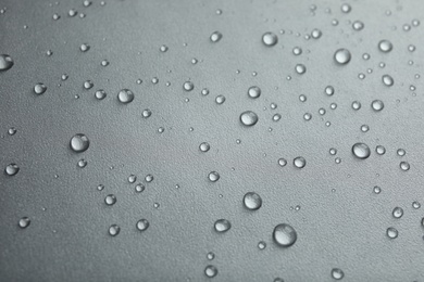 Many clean water drops on grey background