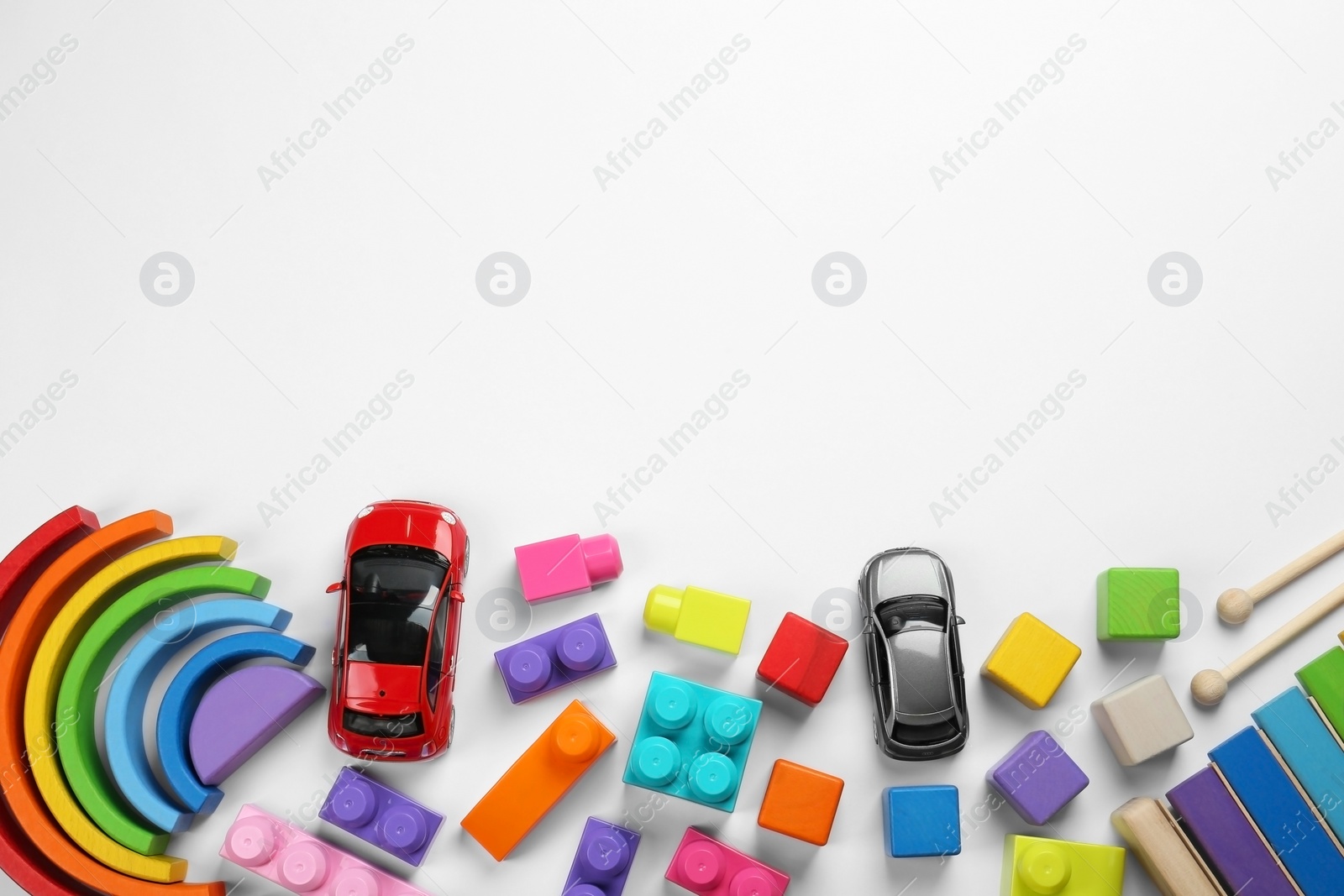 Photo of Different children's toys on white background, flat lay. Space for text