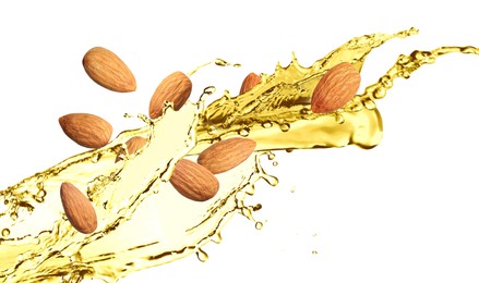 Organic almond oil and tasty nuts flying on white background