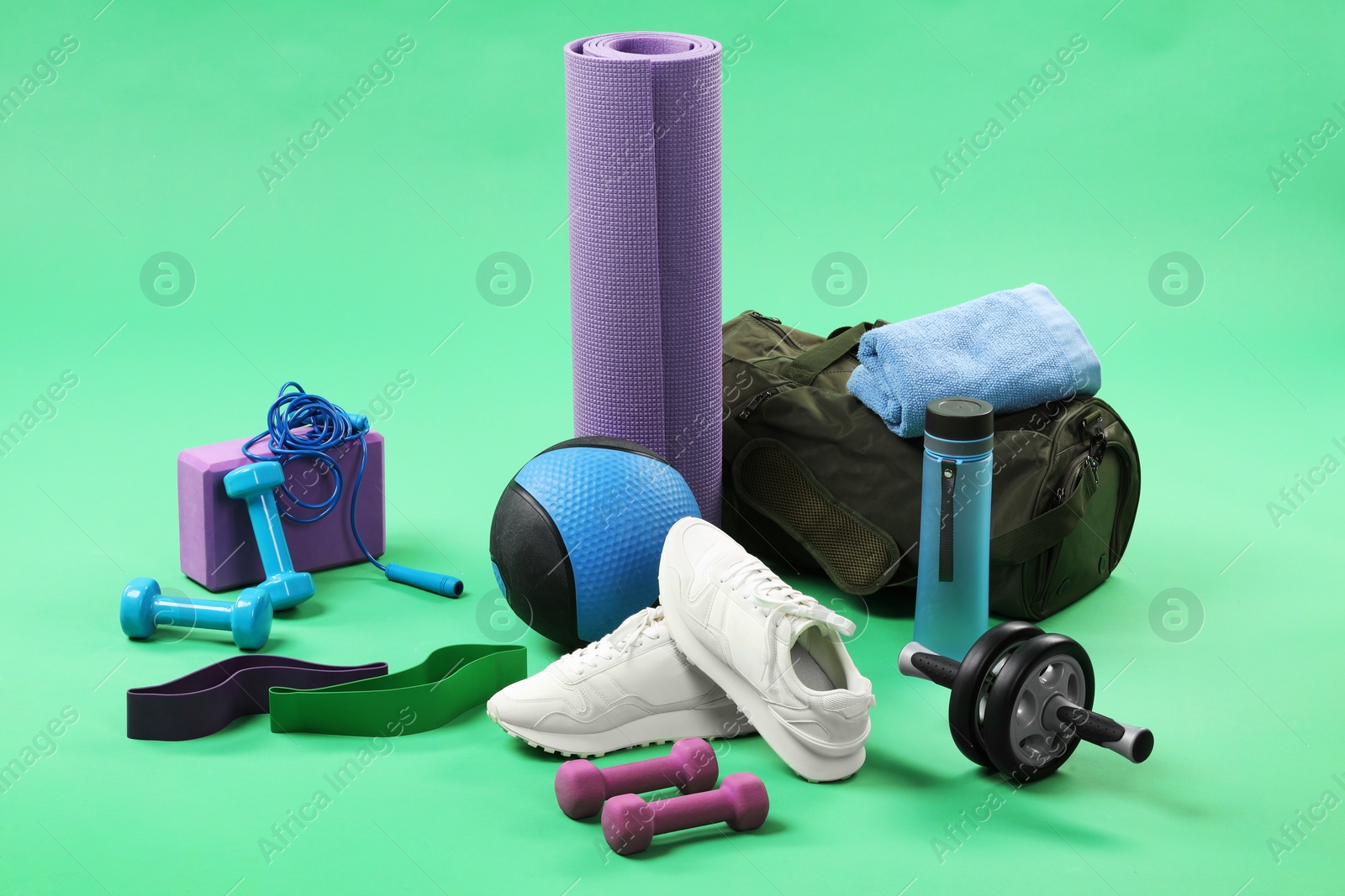 Photo of Many different sports equipment on green background