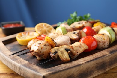 Photo of Delicious shish kebabs with grilled vegetables served on table, closeup