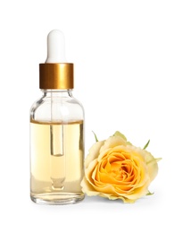 Photo of Bottle of rose essential oil and flower isolated on white