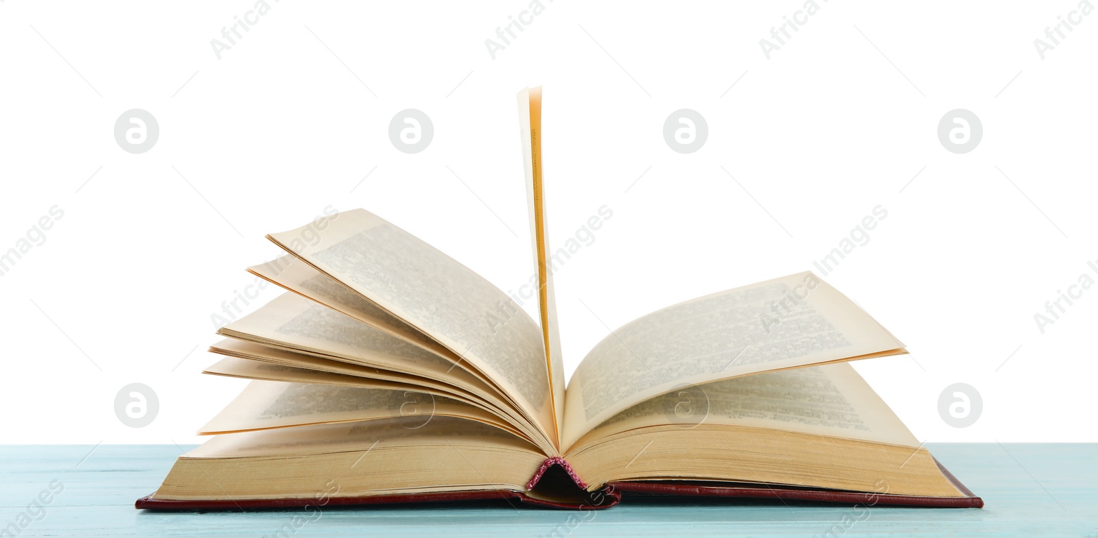 Photo of Open old hardcover book on wooden table