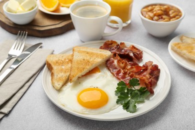 Photo of Delicious breakfast with sunny side up egg served on light table