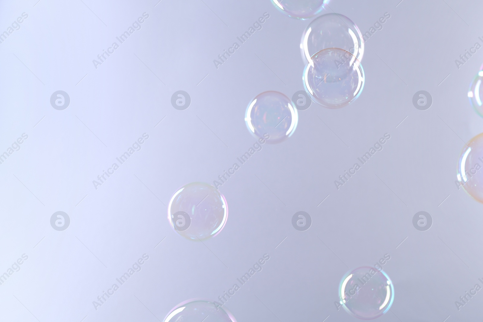 Photo of Beautiful transparent soap bubbles on gray background