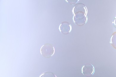 Photo of Beautiful transparent soap bubbles on gray background