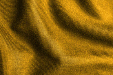 Image of Textured golden fabric as background, closeup view