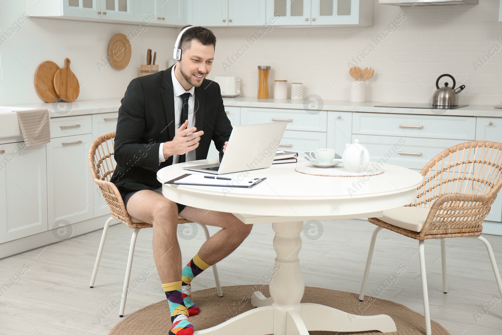 Photo of Businessman in underwear pretending to wear formal clothes during video call at home